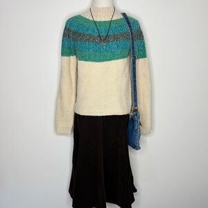 Cream sweater with Green, blue and grey striped top of sweater